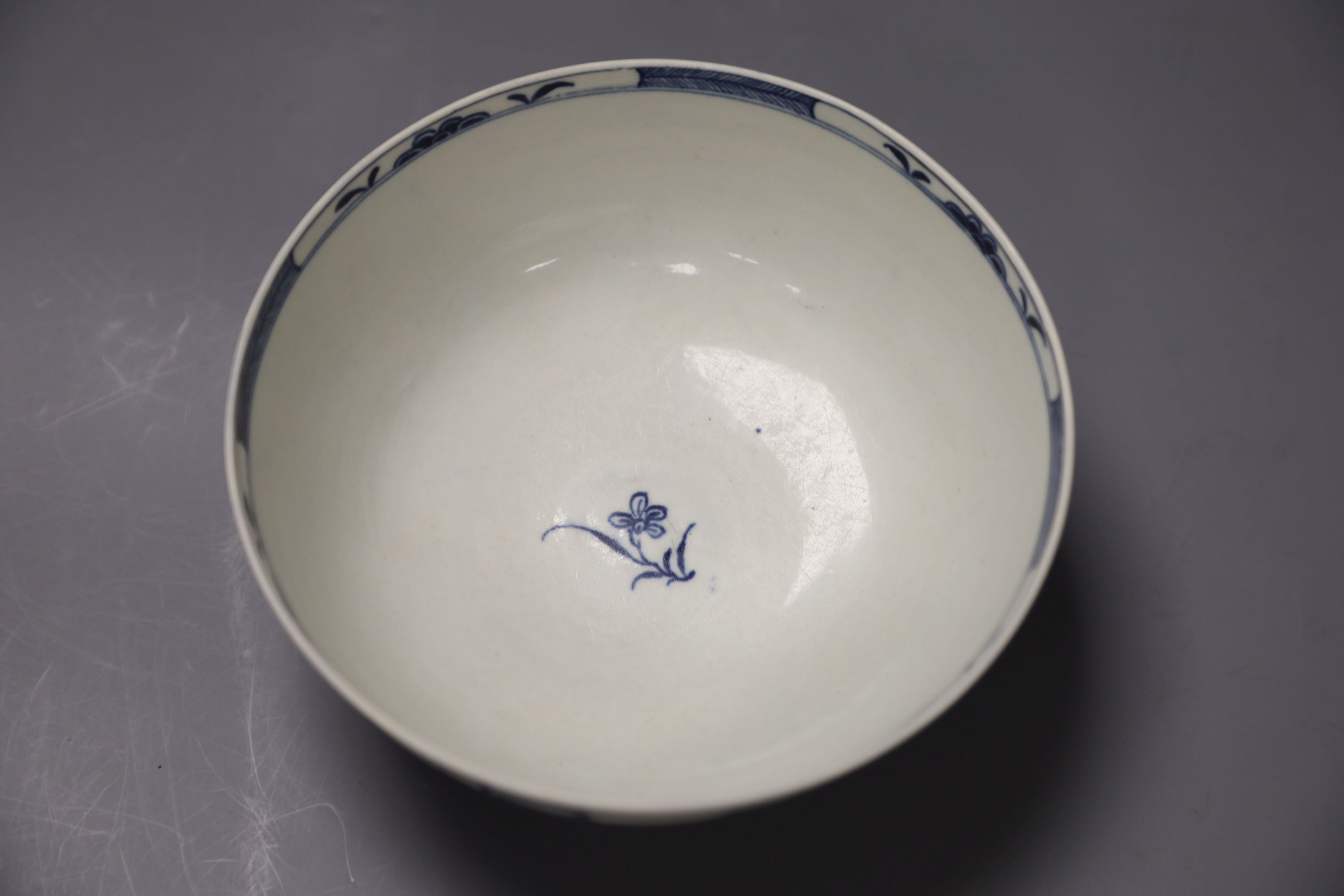 An 18th century Worcester bowl painted with the Candle fence pattern, early crescent mark, diameter 16cm